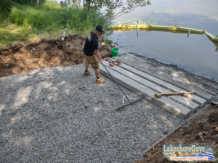 Installing the first prefabbed concrete slabs at the base of the boat ramp