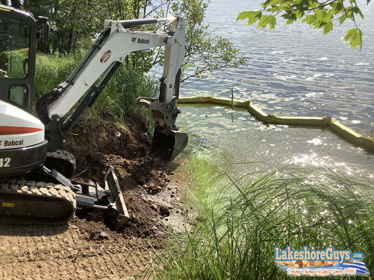 Surface prep: clearing the area and grading the slope for the boat ramp