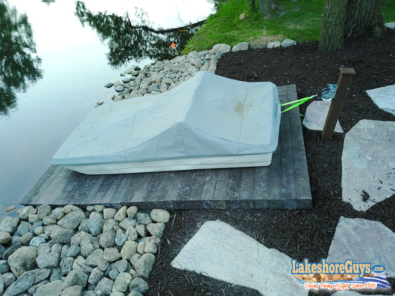 Recycled plastic boat ramp with riprap shoreline, stone walkway, and fire pit - alternate view