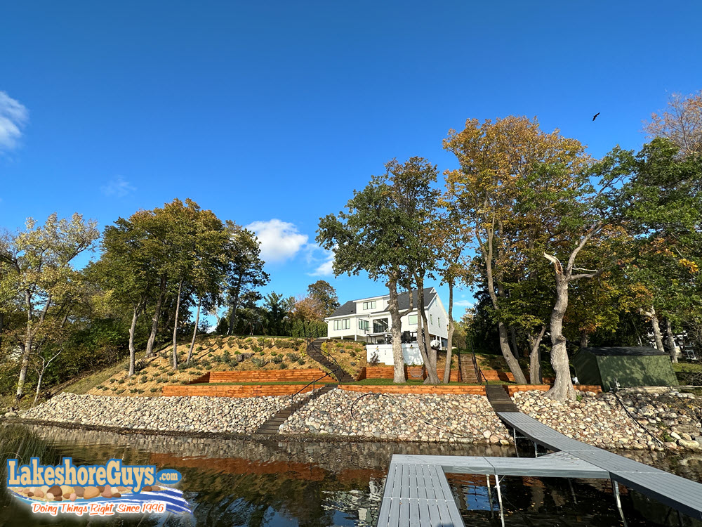 Riprap shoreline with lakefront staircase and timber retaining wall