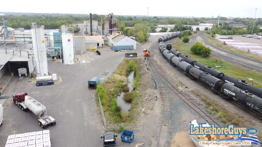 BEFORE: eroding, undersized, dangerous stormwater basin at factory in Minneapolis.